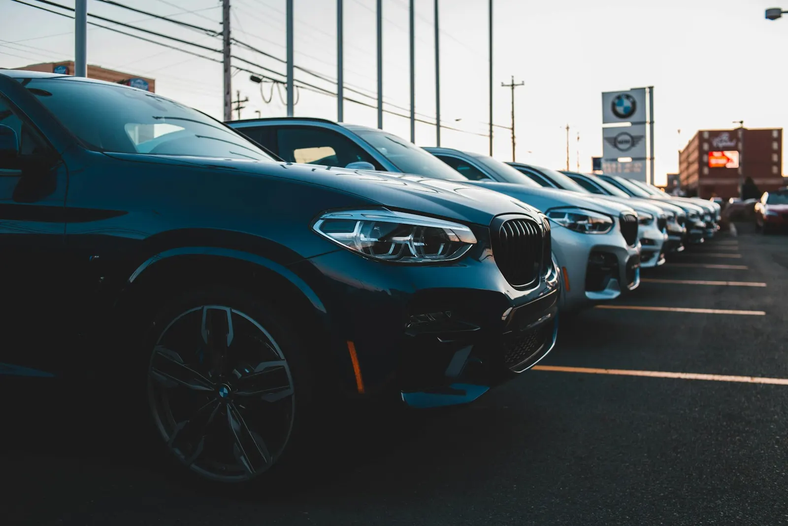 Row of late-model SUVs lined up on a dealership lot